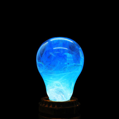 EP Light Memory Resin LED Bulb handcrafted with eco-friendly resin, shown with wooden base options