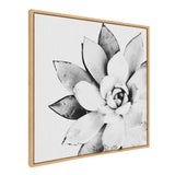 Black and white close-up of a symmetrical succulent with textured leaves, centered on a framed square canvas with a light wood frame.