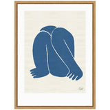 Abstract blue silhouette of a figure with bent legs and arms intertwined, set on a beige background within a wooden frame.