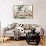 Living room with light gray curved sofa featuring a chevron blanket and round cushion, black woven coffee table with potted plant, and framed cheetah canvas art above.