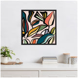 Square framed abstract wall art featuring colorful outlined leaves in teal, mustard, coral, and black on a pale pink background above a white dresser with plant and decorative items
