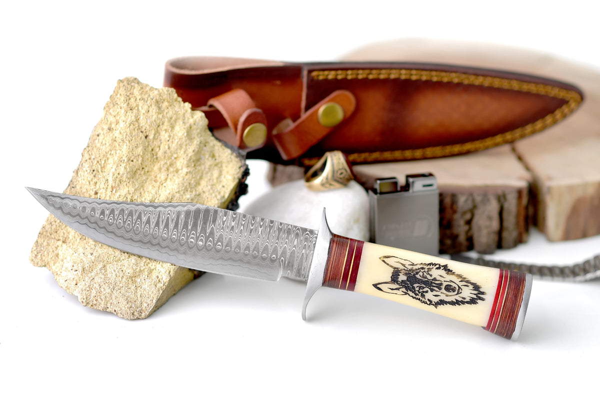 Wilderness Howl Damascus Steel Knife with wolf engraved bone handle showing Ladder Damascus pattern
