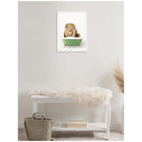 Framed canvas on pale wall depicting a lion sitting in a green clawfoot bathtub surrounded by colorful tiles, above white bench with fur throw and beige bag nearby.