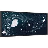 Sylvie Blue and White Iceberg Pattern in Greenland framed canvas art by Michael Schauer, displaying abstract blue and white iceberg shapes on a green background.