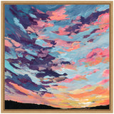 Vibrant sunset painting with bold pink, purple, and blue clouds over a dark silhouetted horizon, framed in natural wood.