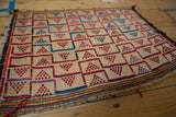 Vintage African Tuareg Rug Mat laid on a light floor showing woven straw pattern and tassels
