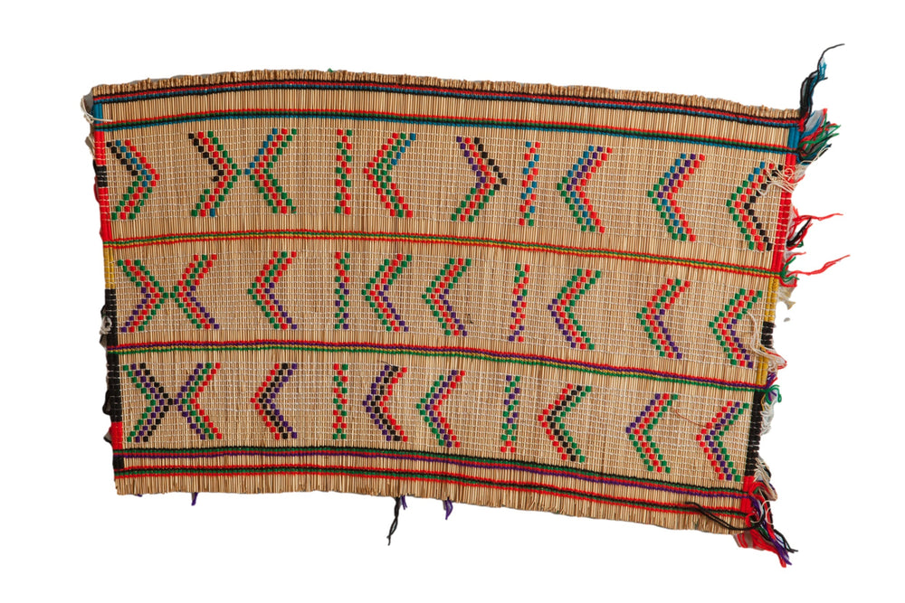 Vintage African Tuareg rug mat handwoven from straw with a geometric pattern in earth tones