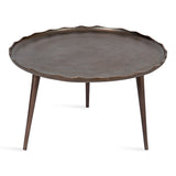 Round coffee table with a dark bronze finish, featuring a wavy scalloped edge and three slender tapered legs, shown against a white background.
