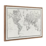 Framed vintage-style world map in black and white with intricate line details and a beaded gold frame, angled to show depth and texture.