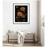 Framed floral artwork with orange and brown poppies on a black background, hanging above a rustic wooden bench with an open book and draped cream fabric in a light, airy room.