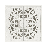 White carved wood wall cabinet with symmetrical floral and leaf patterns forming a circular design centered on two hinged doors.