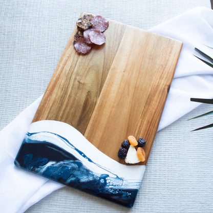 acacia resin serving bread board with fruits on a white towel