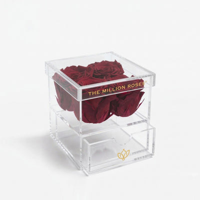 Clear acrylic 4 drawer box topped with four preserved magenta roses