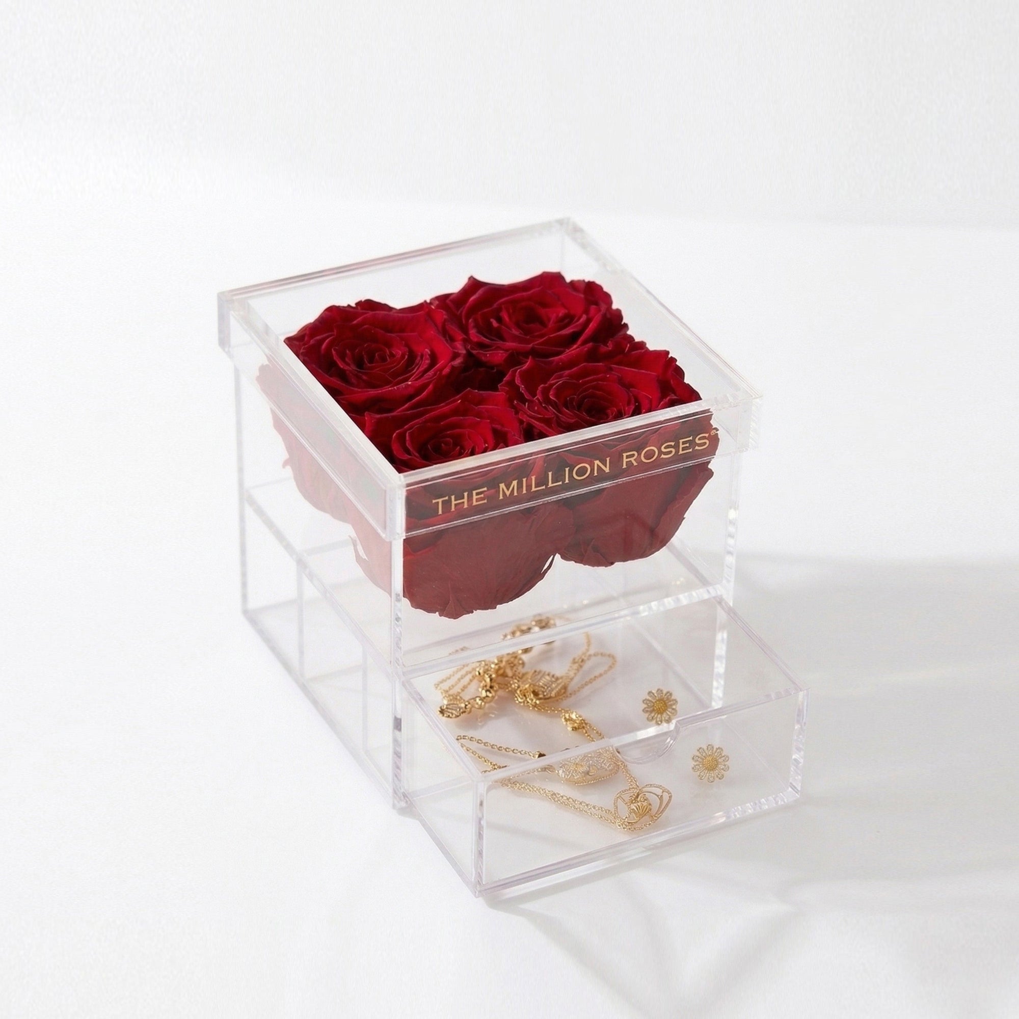 Acrylic 4 Drawer Box with four preserved red roses on top and a clear drawer underneath