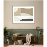 Framed abstract wall art with beige, taupe, white, and dark brown organic shapes hanging above a wooden bench with a green cushion and a beige throw in a tan and green walled seating area.