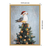 Seagull wearing a red Santa hat perched atop a decorated Christmas tree with glowing orange and white lights against a muted blue background.