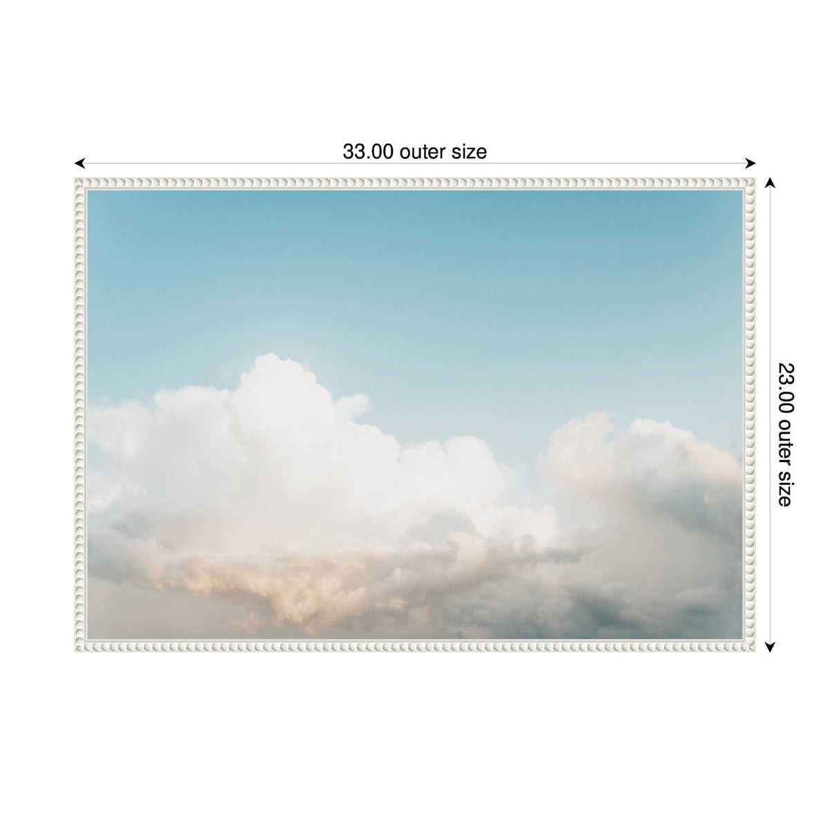 Framed canvas print depicting a sky with soft, fluffy white clouds against a gradient blue background, enclosed in a white beaded frame measuring 33 by 23 inches.