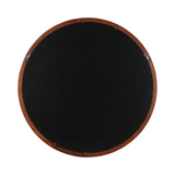 Back view of a round wall mirror with a smooth wooden frame and a black protective backing secured by small screws and two metal hanging brackets.