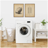 Laundry room with white front-load washing machine centered beneath two vintage-style framed football prints on a white wall, flanked by woven basket and shelf with detergent and plants.