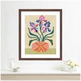 Stylized iris flowers in shades of pink and purple with green leaves in a round, patterned orange and pink vase against a beige background, framed in dark wood.
