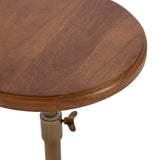 Round wooden tabletop with smooth edges and warm brown grain, attached to a brass adjustable mechanism with a wingnut clamp.