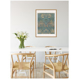 Dining room with light wood chairs and white table featuring a glass vase of white calla lilies, framed William Morris Peacock and Dragon 1878 artwork on pale gray wall.