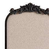 Top section of an arch-shaped pinboard with beige fabric and an ornate black carved frame featuring symmetrical scroll and leaf motifs.