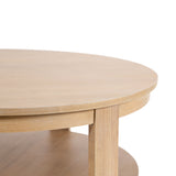 Close-up of a round wooden coffee table with a smooth light wood finish and a lower shelf supported by a straight leg, shown on a white background.
