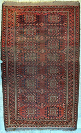 Antique 1880s Baluch rug with dark red and brown tones, featuring geometric octagon motifs and intricate borders, measuring approximately 4 by 7 feet.