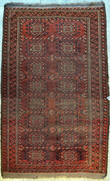 Rectangular antique Baluch rug circa 1880, featuring a repeating geometric pattern in deep red, brown, and black hues with detailed border designs and fringed edges.