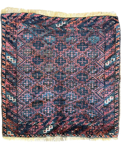 Antique Tribal Baluch Bag Face rug measuring 22 by 24 inches with natural wool pile and tribal design