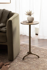 Small round table with a vase and glasses next to a gray sofa in a living room.