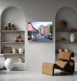 Contemporary living room with arched shelves displaying pottery and decorative objects, featuring a curved brown leather lounge chair beneath a colorful urban street painting.