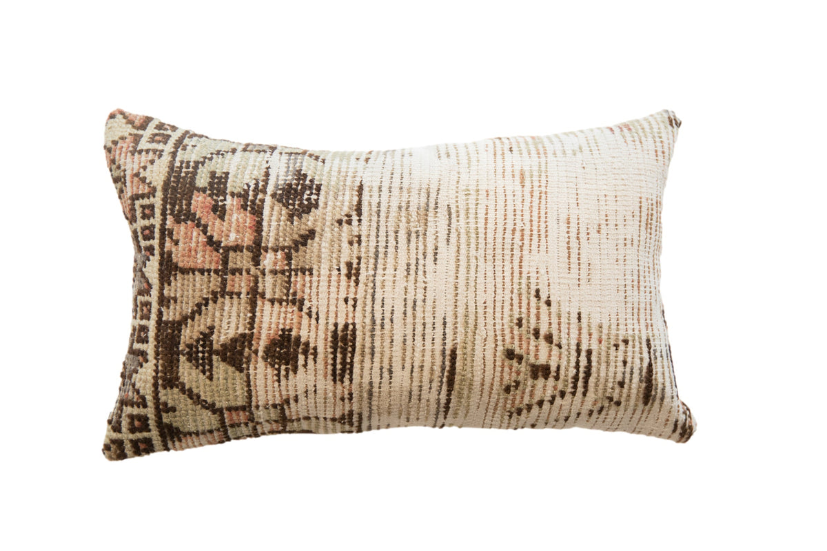 Vintage Rug Fragment Pillow showing floral and geometric patterns in muted reds, blues, and neutrals