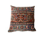 Vintage Meshed Rug Fragment Pillow showing blue and burnt orange tones and aged textile surface