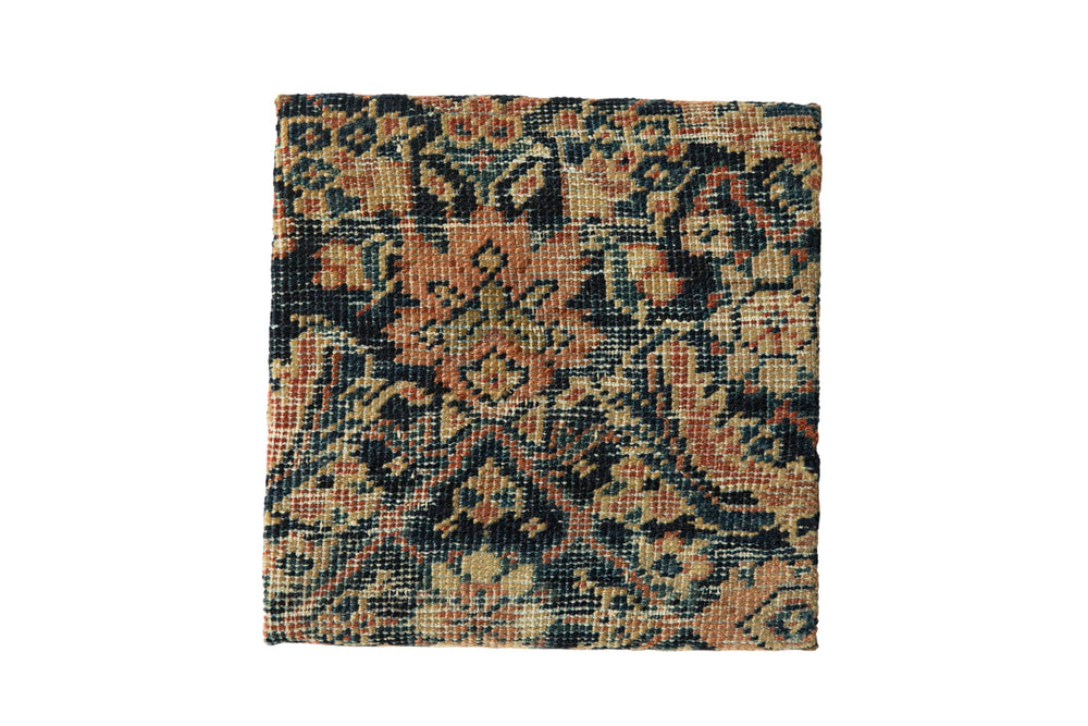 Decorative cork board with antique Persian Fereghan rug fragment showing partial Herati design, framed and mounted.