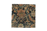 Decorative cork board with antique Persian Fereghan rug fragment showing partial Herati design, framed and mounted.