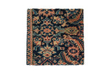 Decorative cork board featuring an antique Fereghan rug fragment with navy blue, ivory, red, rose, and green shades