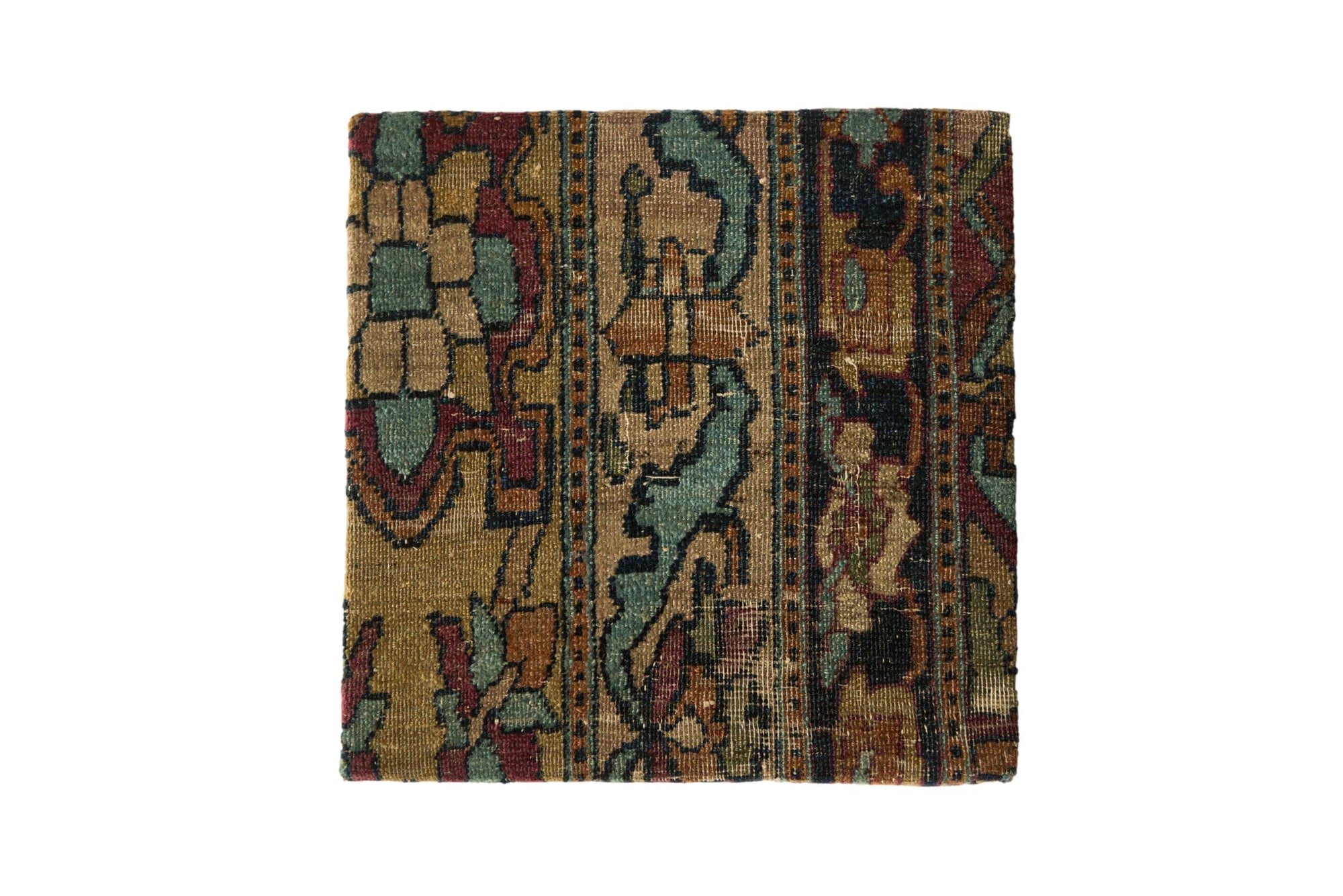 Decorative cork board featuring antique Kerman rug fragment with red and blue pattern and concealed cork backing