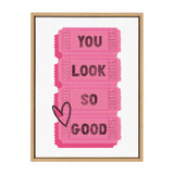 Four vertically stacked pink tickets with black text reading 'YOU LOOK SO GOOD' and a black heart outline overlapping the bottom left ticket, framed in wood.