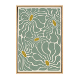 Framed canvas artwork featuring abstract floral shapes with flowing teal petals and mustard yellow centers on a cream background, by Carrie Cantwell.