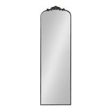 Tall rectangular arch-top mirror with an ornate dark carved crest at the top center and a thin dark frame surrounding the glass.
