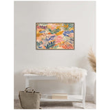 Abstract floral painting with layered leaves and flowers in warm pink, orange, blue, and green hues in a simple frame above a white bench with a white fur throw and beige bag nearby.
