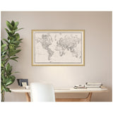 Vintage-style black and white linen world map framed and hung on a beige wall above a light wood desk with white chair and plant beside it