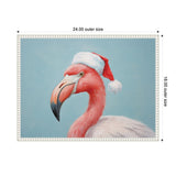 Close-up portrait of a flamingo with pink and white feathers wearing a red and white Santa hat against a pale blue background, framed in white with bead detailing.