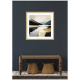 Abstract landscape painting in a gold frame showing a mountain lake with muted earthy tones, hanging on a dark gray wall above a rustic wooden bench with two woven baskets beneath.