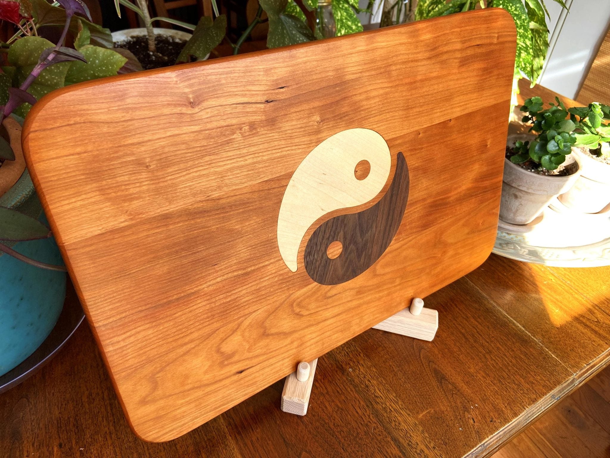 Cherry wood charcuterie board with Yin Yang inlay of Maple and Peruvian Walnut