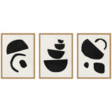 Triptych of framed abstract prints featuring black geometric shapes on white backgrounds with varied curved and angular forms, arranged with light wooden frames.