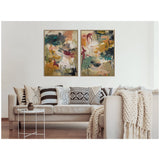 Two abstract expressionist canvases with teal, ochre, rust, and beige brushstrokes in light wood frames above a beige sofa with patterned pillows and a chunky knit throw.