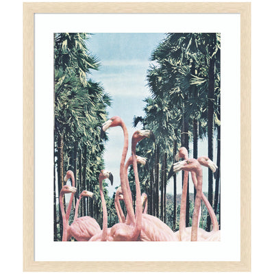 Framed art print showing pink flamingos standing among tall palm trees under a bright sky